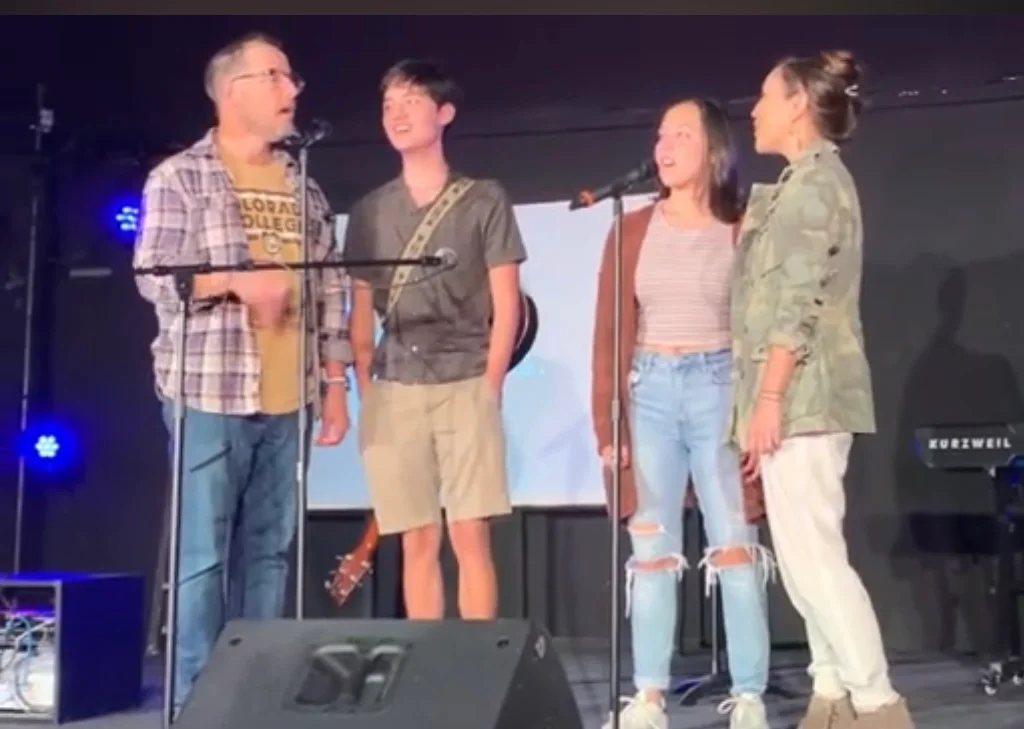 Dr. Jean Chang-Lowe singing on stage with her family